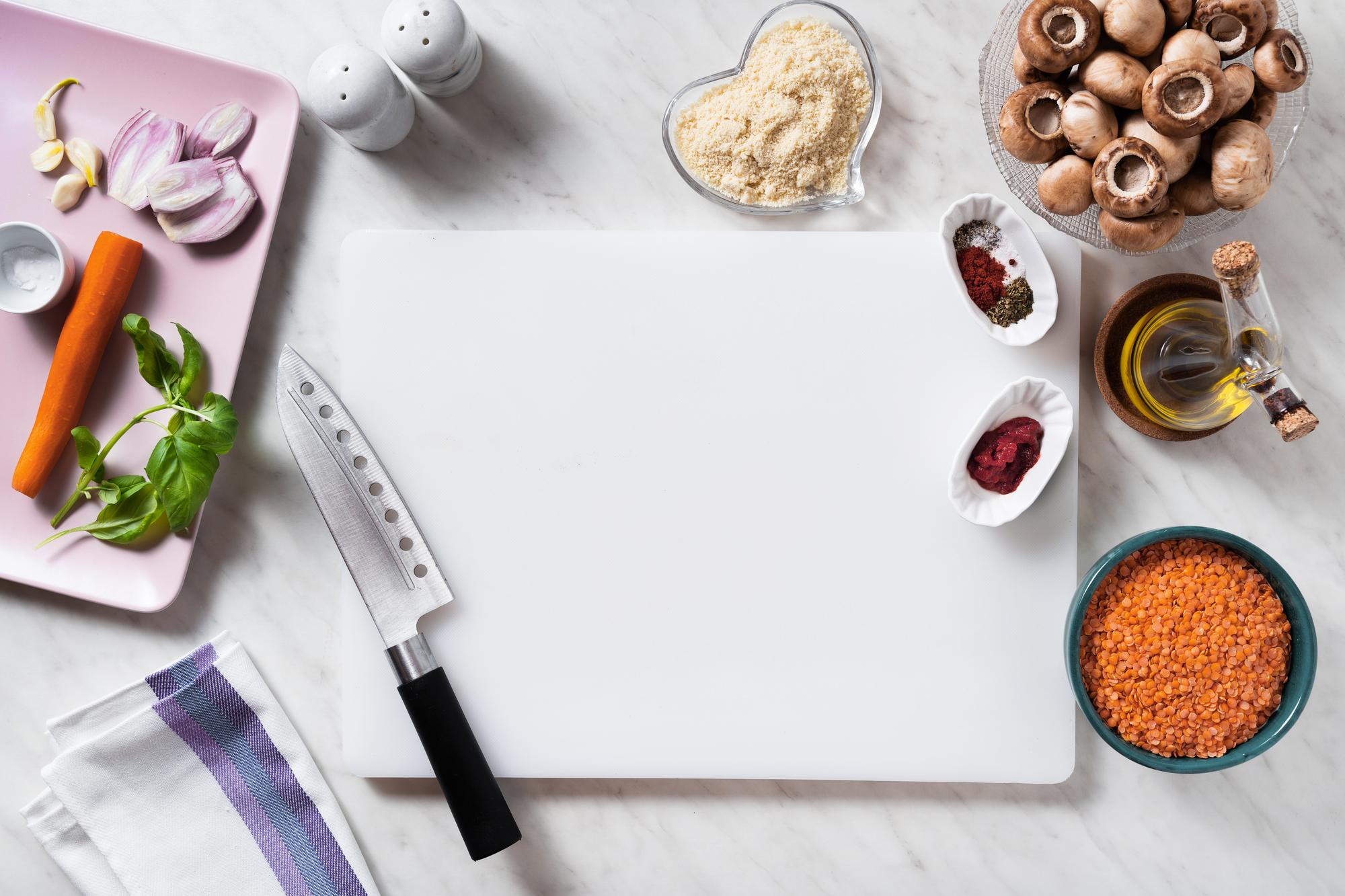 Assorted cooking tools and recipe notes on a table